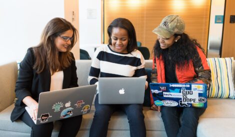 three woman in front of laptop computer